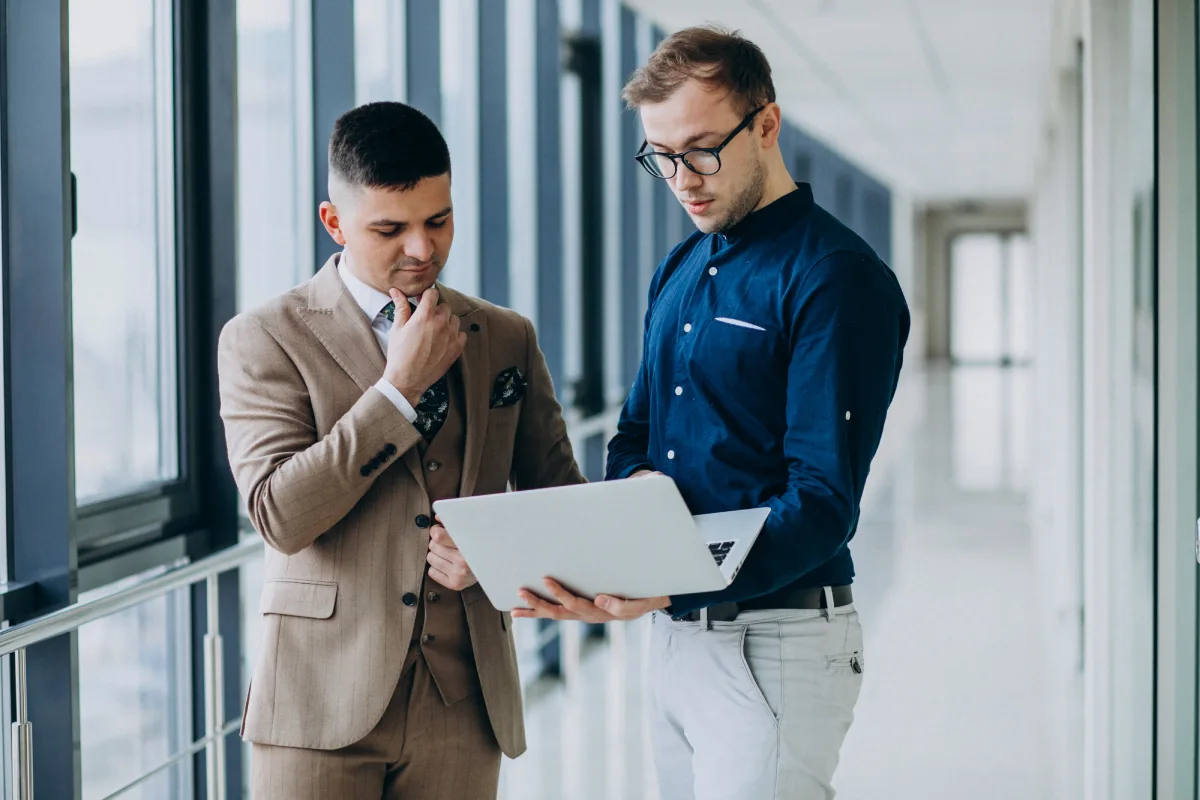 Two professionals reviewing business strategies on a document in a modern office